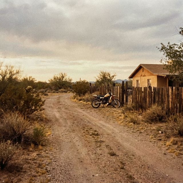 A dusty, semi-rural property in Arizona in the 1980s with a dirt bike.